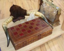 A three bottle tantalus (no key), mounted horns and a leather games box