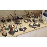 A quantity of taxidermic antlers, horns and deer feet, several on Black Forest mounts