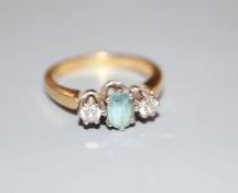 A modern 18ct gold, aquamarine and diamond three-stone ring, size M, gross 5 grams.CONDITION: