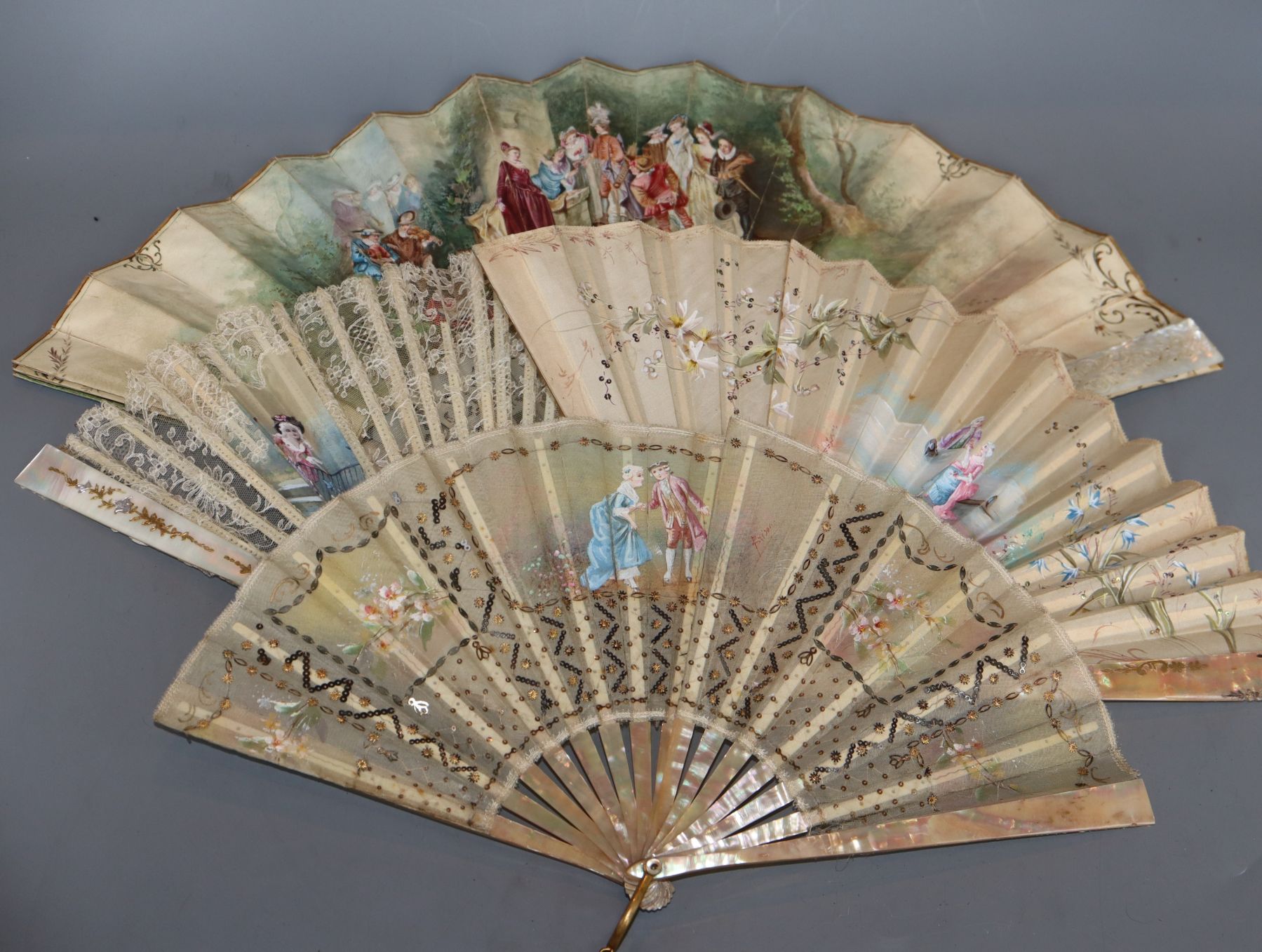 A 19th century French mother-of-pearl and painted parchment fan and three mother-of pearl guarded