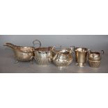 A small silver Christening mug, two silver cream jugs, a silver sauceboat and a sugar bowl,