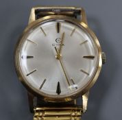 A gentleman's 1960's? 9ct gold Cyma manual wind wrist watch, on later associated bracelet.CONDITION: