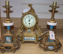 A 19th century French Louis XVI style ormolu mantel clock and a pair of associated spelter table