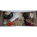 A three drawer trolley containing various dolls wigs, lengths of ribboning, braiding etc