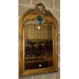 A late 19th century French gilt carved wood and gesso wall mirror, the plate surmounted by a tied