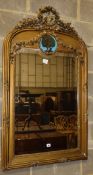 A late 19th century French gilt carved wood and gesso wall mirror, the plate surmounted by a tied