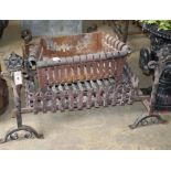 Three wrought iron fire baskets and a pair of dogs, largest basket W.70cm
