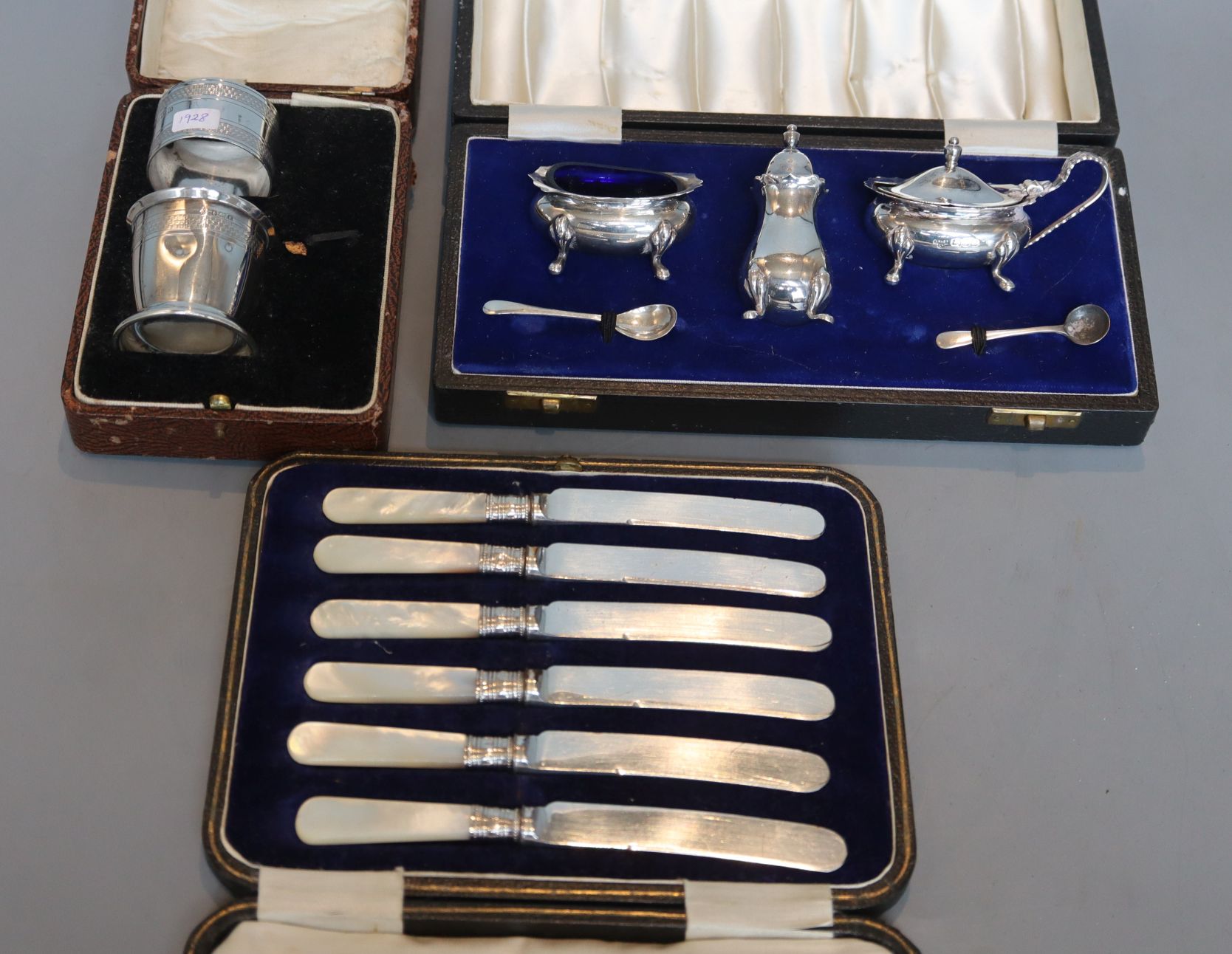 A cased modern three piece silver condiment set, London, 1967, a cased silver part christening set