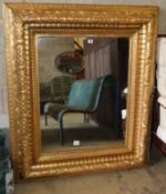 A Victorian carved giltwood "picture frame" wall mirror, with bevelled plate, W.110cm, H.130cm