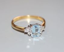 A modern 18ct gold aquamarine and diamond set dress ring, size R, gross 3.4 grams.CONDITION: Good