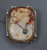 A white metal (tests as 14k) mounted cameo shell pendant brooch, with inset diamond and carved