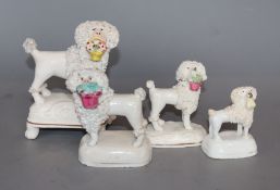 Four Staffordshire porcelain figures of a poodle grasping a basket in its mouth, c.1840 -50, H. 6.