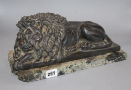 After Canova, a bronze recumbent lion, on a marble plinth, length 35.5cm