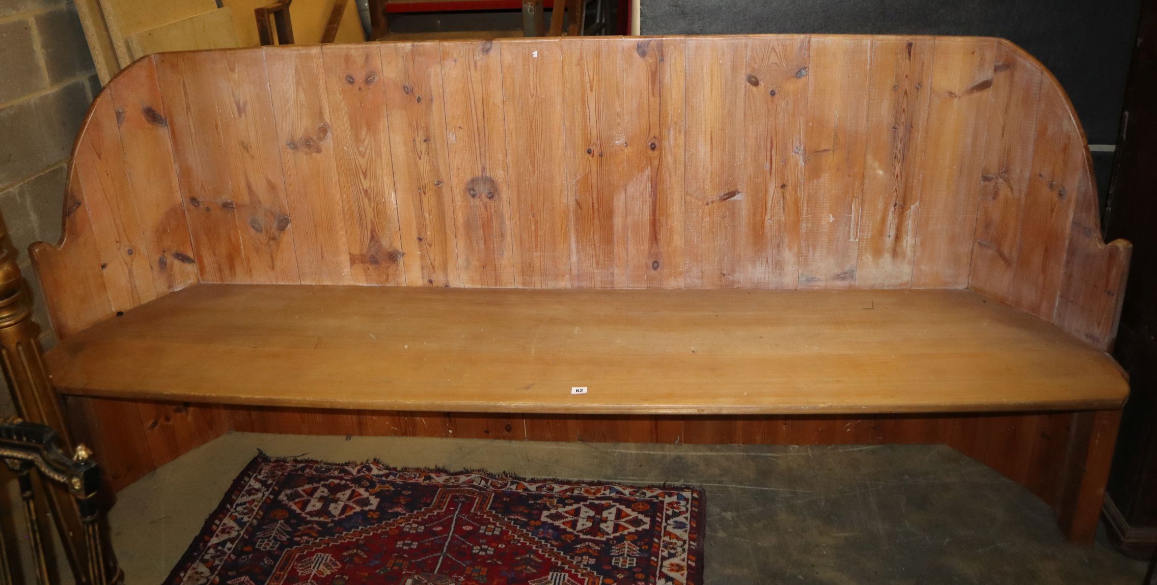 A pine settle, W.238cm, D.48cm, H.108cm