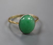 An 18ct and oval cabochon jade set ring, size Q, gross 2.8 grams.CONDITION: Tiny split on side of