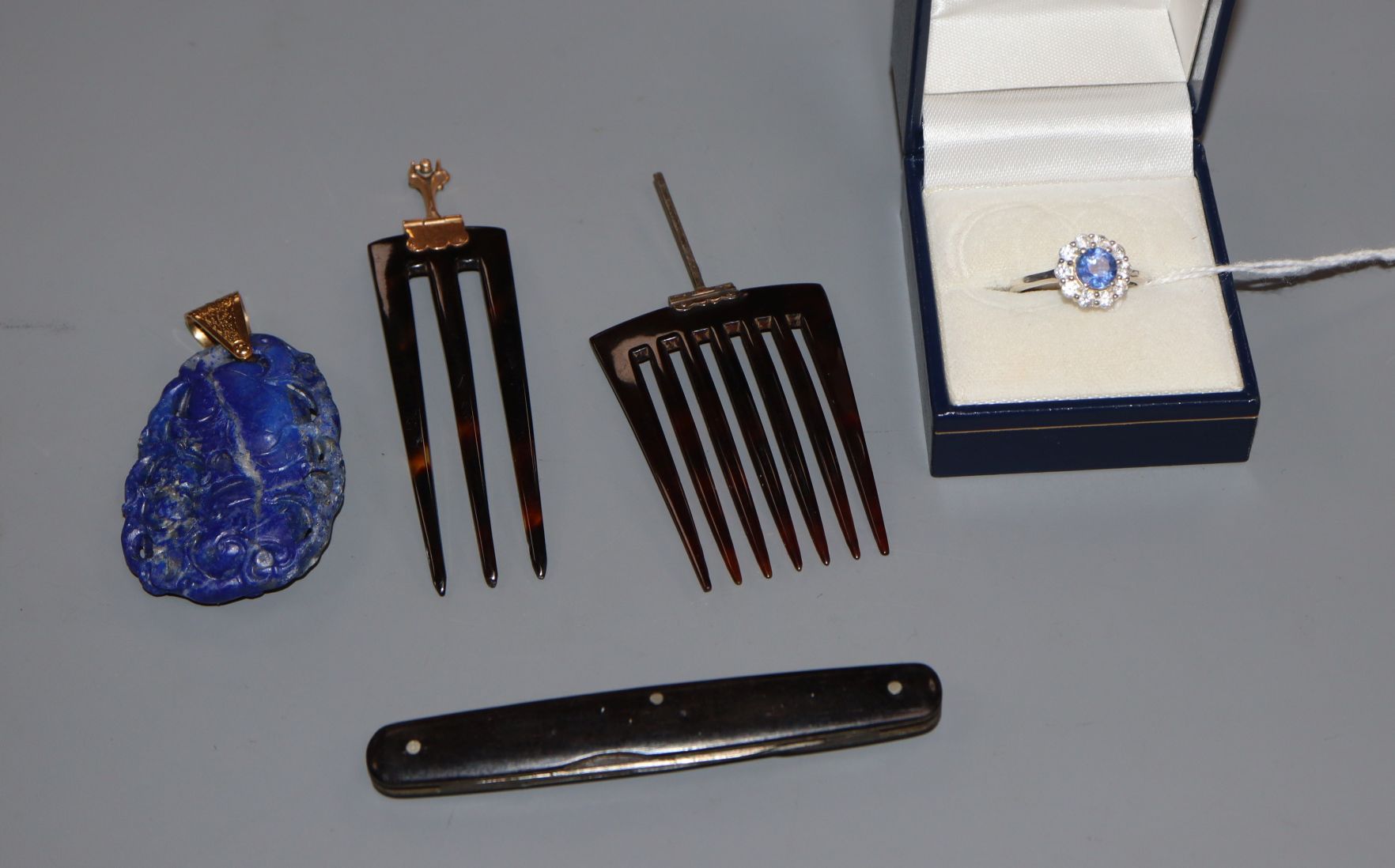 A modern 925, sapphire and paste set dress ring, a carved lapis lazuli pendant, two tortoiseshell