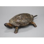 A Victorian cast iron and simulated tortoiseshell table bell, modelled as a tortoise, length 17cm