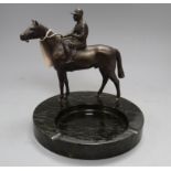 A spelter model of a horse and jockey, surmounted on a serpentine ashtray, height 23cm