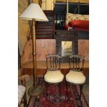 A pair of Victorian ebonised parcel gilt side chairs and a standard lamp