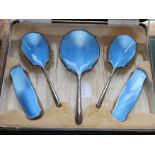 A George V five-piece silver and blue guilloche enamel dressing table set, cased, W G Sothers Ltd,