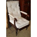 An early Victorian rosewood reclining armchair