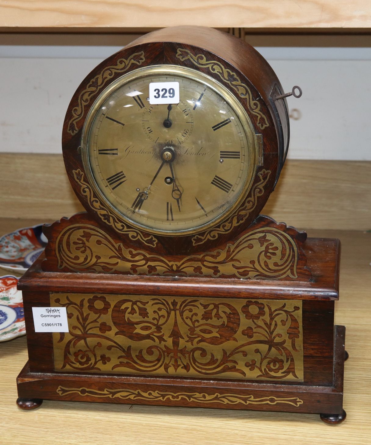 Ganthony of London. A brass inlaid rosewood mantel timepiece, height 44cm single fusee movement,