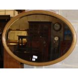 An oval giltwood bevelled wall mirror, W.96cm, H.65cm