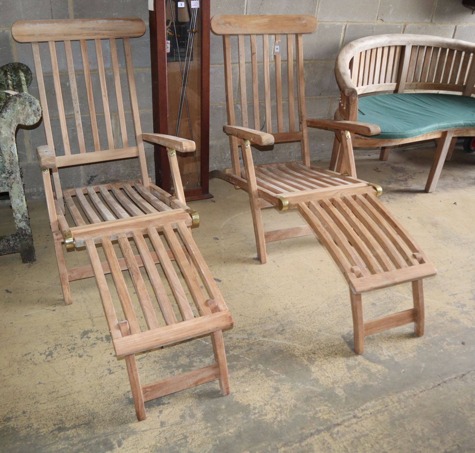 A pair of teak garden steamer chairsCONDITION: As new condition