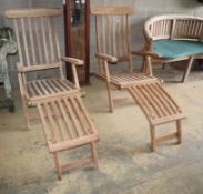 A pair of teak garden steamer chairsCONDITION: As new condition