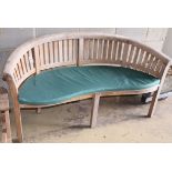 A teak banana garden bench, W.160cm, D.60cm, H.85cmCONDITION: Slightly bleached appearance but