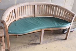 A teak banana garden bench, W.160cm, D.60cm, H.85cmCONDITION: Slightly bleached appearance but