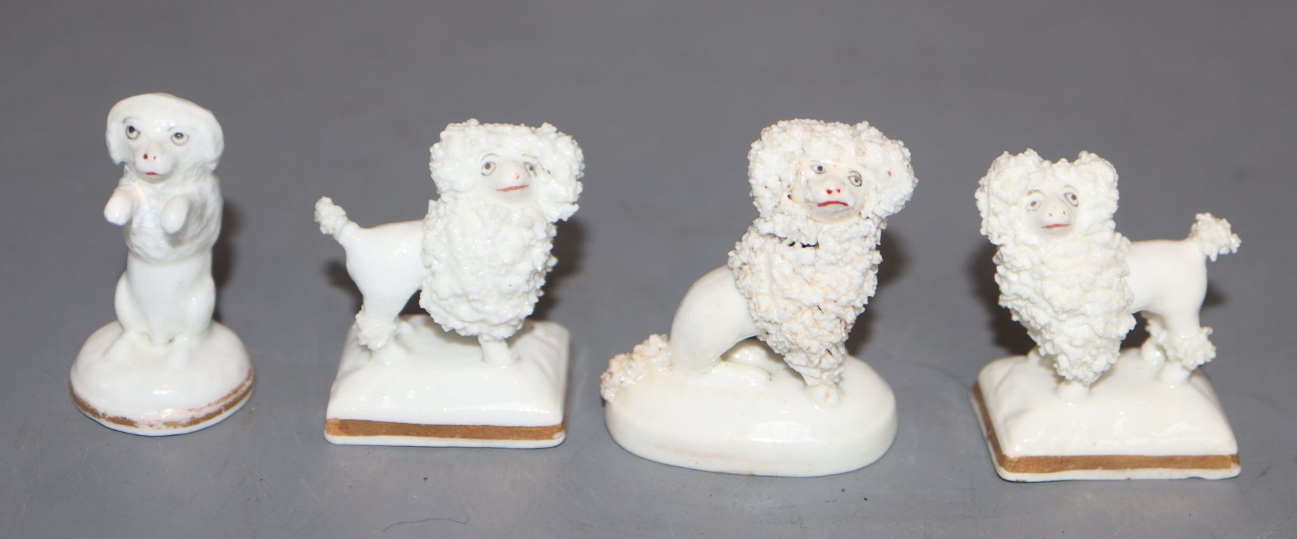 Four Staffordshire porcelain toy figures of poodles, c.1830-50, H. 3.7 - 4cm