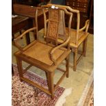 A pair of Chinese Ming style hardwood elbow chairs, with caned seats, W.54cm, D.48cm, H.95cm