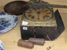 An early 19th century French wall clock, with an alabaster face and ebonised brass surround, above a