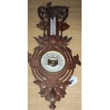 A Black Forest carved wall barometer, height 62cm
