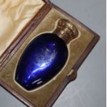 A Victorian engraved gilt white metal mounted blue glass scent bottle, in fitted case, 85mm.