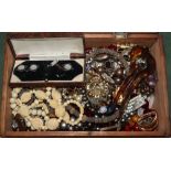 A small box of assorted costume jewellery.