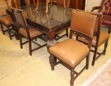 An 18th century style oak draw leaf dining table and a set of six 1920's Jacobean style oak dining