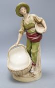 A Royal Dux figure of a boy carrying baskets, height 40cmCONDITION: This appears to have rarely been