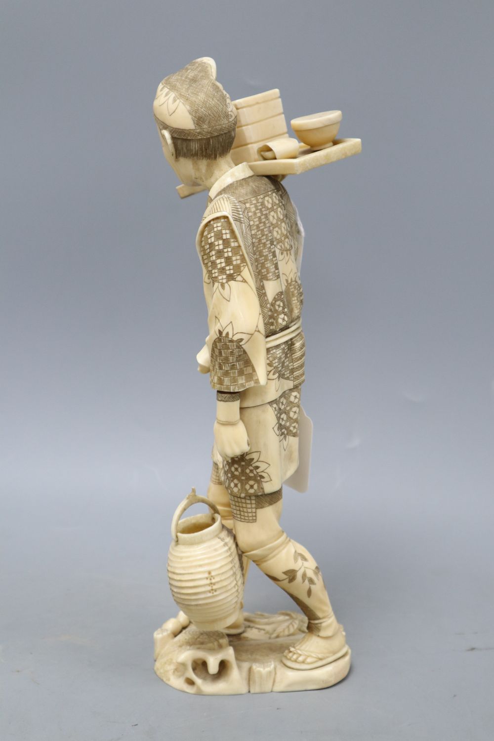 A Japanese Meiji walrus ivory figure of a tradesman, height 32cm - Image 2 of 4