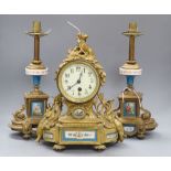 A 19th century French Louis XVI style ormolu mantel clock and a pair of associated spelter table