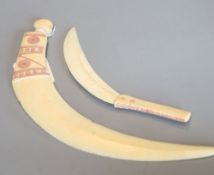 Two tribal carved warthog or boar's tusk daggers, first half 20th century, picked out in red