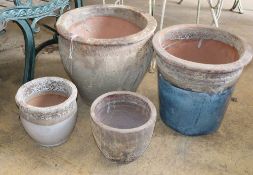 Four earthenware garden pots, largest 36cm diameter, H.33cmCONDITION: One of the pots has a vertical