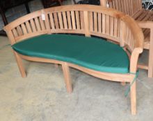 A teak banana garden bench, W.160cm, D.60cm, H.83cmCONDITION: A new condition