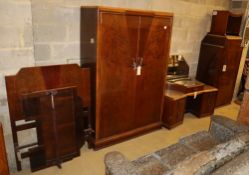 Two Art Deco style figured walnut wardrobes, a dressing table, a stool and a single bed frame,