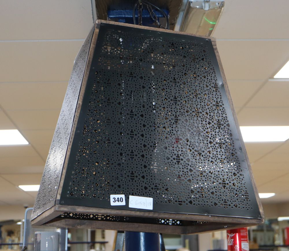 A contemporary square pierced metal ceiling shade