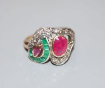 A modern 14k, ruby, emerald and diamond set dress ring, size J, gross 3.1 grams.CONDITION: One