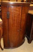 A Georgian mahogany bow-fronted hanging corner cupboard, W.70cm, D.50cm, H.104cm