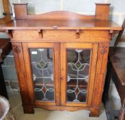 A Liberty Arts & Crafts oak bookcase, W.104cm, D.34cm, H.125cmCONDITION: The top is stained