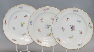 Three Meissen floral and gilt decorated plates, diameter 24cmCONDITION: One dish has a large area of